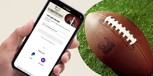 BetMGM sports banner showing a hand holding a phone with the BetMGM registration process on the screen